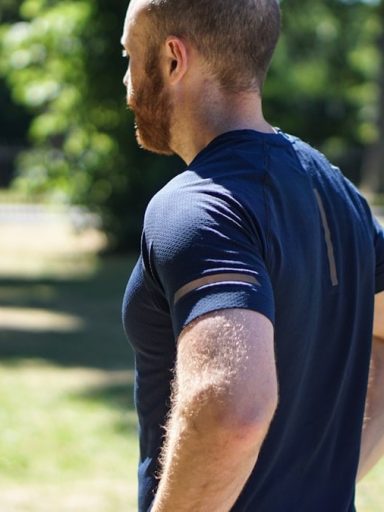 selective focus photography of man standing near trees